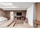 Living area featuring wood paneling, sunken carpeted area, and whitewashed brick fireplace at 14828 N Skokie Ct, Phoenix, AZ 85022