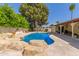 Backyard pool with rock waterfall and mature landscaping at 14828 N Skokie Ct, Phoenix, AZ 85022