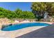 Beautiful pool with rock waterfall feature and lush landscaping at 14828 N Skokie Ct, Phoenix, AZ 85022
