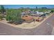 Aerial view of the tan home featuring mature trees, gravel landscaping, and a fenced backyard at 1526 W Huntington Dr, Tempe, AZ 85282