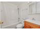 A bathroom features a sink with wooden cabinet, toilet and bathtub with shower and white shower curtain at 1526 W Huntington Dr, Tempe, AZ 85282