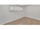 Bright, minimalist bedroom with wood-look floors and a window at 1526 W Huntington Dr, Tempe, AZ 85282