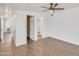 Bedroom with laminated wood flooring and ceiling fan, which leads to bathroom and closet at 1526 W Huntington Dr, Tempe, AZ 85282