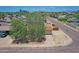 A tan home featuring mature shade trees, gravel landscaping, and a driveway leading to the garage at 1526 W Huntington Dr, Tempe, AZ 85282