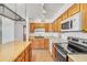Close-up of kitchen features stainless steel appliances, island and plenty of light at 1526 W Huntington Dr, Tempe, AZ 85282