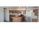 Updated kitchen with island, stainless appliances, and oak cabinetry for storage and style at 1526 W Huntington Dr, Tempe, AZ 85282