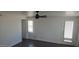 Well-lit room featuring a modern ceiling fan, clean white walls, and a gray wood-look floor at 1526 W Huntington Dr, Tempe, AZ 85282
