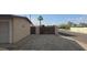 Gated side yard with gravel cover, and access to adjacent street and driveway to the main house at 1526 W Huntington Dr, Tempe, AZ 85282