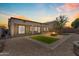 Spacious backyard with a stone fire pit, patio area, and minimalist desert landscaping at 15564 W Mescal St, Surprise, AZ 85379