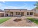 Paver patio with built-in firepit and low maintenance desert landscaping at 15564 W Mescal St, Surprise, AZ 85379