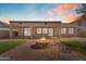 Relaxing outdoor space with a stone fire pit and a brick-paved patio, perfect for entertaining at 15564 W Mescal St, Surprise, AZ 85379