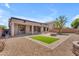 Spacious backyard featuring desert landscaping, block fence, and stone firepit at 15564 W Mescal St, Surprise, AZ 85379