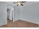 Bedroom featuring a ceiling fan and access to another room, creates a comfortable and adaptable layout at 15564 W Mescal St, Surprise, AZ 85379