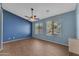 Spacious bedroom with wood floors, a ceiling fan, and large windows for natural light at 15564 W Mescal St, Surprise, AZ 85379