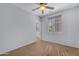 Bedroom features ceiling fan, window with blinds, and doorway view, creating a comfortable and well-lit space at 15564 W Mescal St, Surprise, AZ 85379