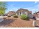 Lovely home featuring desert landscaping, arched windows, and a well-maintained yard at 15564 W Mescal St, Surprise, AZ 85379