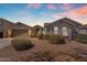 Inviting home exterior featuring desert landscaping, a tidy lawn, and a neutral color palette at 15564 W Mescal St, Surprise, AZ 85379