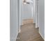 A hallway with wood like tile and grey walls that leads to a bedroom at 15564 W Mescal St, Surprise, AZ 85379