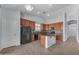 Bright kitchen featuring wood cabinets, tile floors, and a center island at 15564 W Mescal St, Surprise, AZ 85379