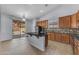 Bright kitchen featuring wood cabinets, tile floors, and a center island at 15564 W Mescal St, Surprise, AZ 85379