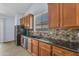 Kitchen features include tile backsplash, granite counters, and stainless steel sink at 15564 W Mescal St, Surprise, AZ 85379