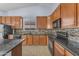 Kitchen boasts stainless steel appliances, granite counters, and plenty of cabinet space at 15564 W Mescal St, Surprise, AZ 85379