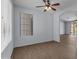 Open-concept living room with modern fan, sleek flooring, and bright natural light at 15564 W Mescal St, Surprise, AZ 85379