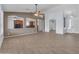 Open-concept living area with neutral paint, tile flooring, and view into kitchen at 15564 W Mescal St, Surprise, AZ 85379