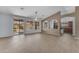 Bright living room with tile floors, ceiling fan, and sliding glass doors to backyard patio at 15564 W Mescal St, Surprise, AZ 85379