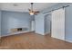 Bright living room features a modern ceiling fan, sleek flooring, and a unique sliding barn door at 15564 W Mescal St, Surprise, AZ 85379