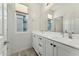 Well-lit bathroom with double sinks, white cabinets and a large mirror offering ample counter space at 16027 N 74Th Ln, Peoria, AZ 85382