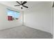 Bright bedroom with a ceiling fan, natural light, and neutral carpet is ready for your personal touch at 16027 N 74Th Ln, Peoria, AZ 85382