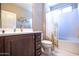 Bathroom with vanity, toilet, and a shower with cactus curtain at 16913 W Holly St, Goodyear, AZ 85395