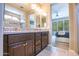 Bathroom featuring a double sink vanity with access to bedroom at 16913 W Holly St, Goodyear, AZ 85395