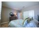 Bedroom with bed, dresser, TV, closet and neutral walls at 16913 W Holly St, Goodyear, AZ 85395