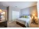 Comfortable bedroom featuring a bed, dresser, and closet at 16913 W Holly St, Goodyear, AZ 85395
