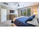 Cozy bedroom features plush bedding, a large window, and dresser at 16913 W Holly St, Goodyear, AZ 85395