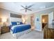 Bedroom showcases a king bed with blue bedding and an ensuite bathroom at 16913 W Holly St, Goodyear, AZ 85395