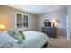 Cozy bedroom with a dresser, tv, and a sunlit window at 16913 W Holly St, Goodyear, AZ 85395
