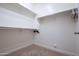 Walk-in closet features ample storage space with shelving and racks at 16913 W Holly St, Goodyear, AZ 85395