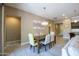 Elegant dining room featuring a stylish chandelier and a view into the kitchen at 16913 W Holly St, Goodyear, AZ 85395