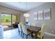 Bright dining room with an outdoor view, stylish lighting, and comfortable seating at 16913 W Holly St, Goodyear, AZ 85395