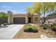 Charming single-story home featuring a neutral-toned exterior, landscaped front yard, and attached two-car garage at 16913 W Holly St, Goodyear, AZ 85395