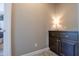 Hallway nook with a stylish cabinet and lamp, adding a touch of elegance to the space at 16913 W Holly St, Goodyear, AZ 85395