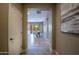 Hallway view leading to a dining area, with tile flooring and neutral paint at 16913 W Holly St, Goodyear, AZ 85395