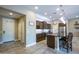 Modern kitchen features a large center island with seating, granite countertops, and stainless steel appliances at 16913 W Holly St, Goodyear, AZ 85395