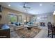Inviting living room with neutral decor, tile flooring, and a comfortable seating arrangement at 16913 W Holly St, Goodyear, AZ 85395