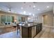 Open concept area showing the kitchen with eat in island looking into the Gathering and dining area at 16913 W Holly St, Goodyear, AZ 85395