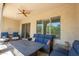 Spacious covered patio with stylish seating around a fire pit table at 16913 W Holly St, Goodyear, AZ 85395