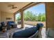 Covered patio with comfortable seating, fan, and a gas grill at 16913 W Holly St, Goodyear, AZ 85395